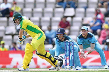 Steve Smith of Australia plays a shot as Jos Buttler and Ben Stokes of England look on during the England vs. Australia match